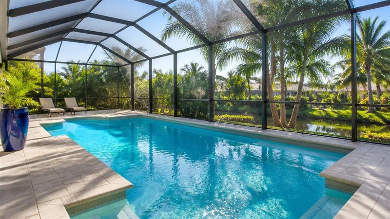Clean, sparkling screened-in Florida pool in bright morning light